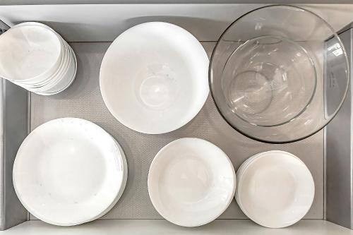 a group of white plates and a bowl in a drawer at Luxury apartment Orlando in Adeje