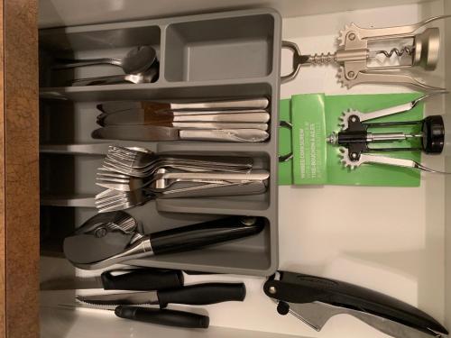 a drawer full of utensils on a counter at Quiet 2 Bed 2 Bath close to Westview Hospital in Stony Plain