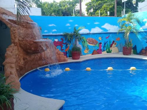 a pool in a water park with a mural at HOTEL PARAISO ACAPULCO in Acapulco