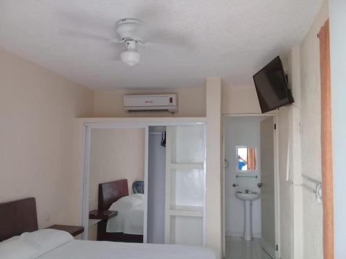 a bedroom with a bed and a television on the ceiling at HOTEL PARAISO ACAPULCO in Acapulco