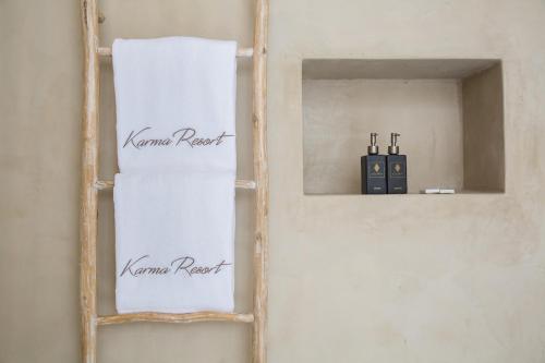 a wooden shelf with two towels on a wall at Karma Resort in Bophut 