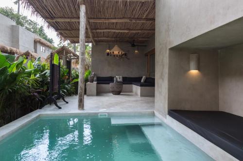 a swimming pool in the middle of a house at Karma Resort in Bophut 