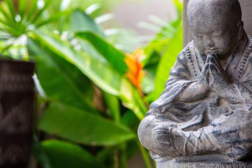a statue of a small child holding a cross at Karma Resort in Bophut 