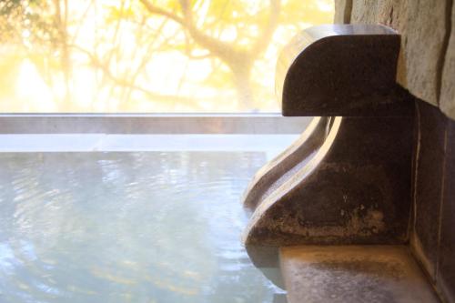 a close up of a stone ledge of a window at Centurion Hakone Bettei in Hakone