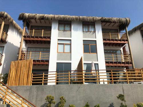 a building with balconies on the side of it at PARADISE EN VICHAYITO in Vichayito