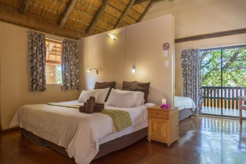 a bedroom with a large bed with a cross on it at Sodwana Bay Lodge Dive & Fishing Resort in Sodwana Bay