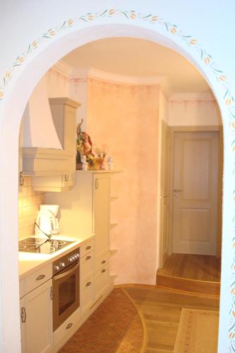 an archway in a kitchen with a sink and a stove at Gästehaus Moser in Ramingstein