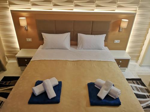 a bedroom with a bed with two towels on it at Louis Luxury Villa by living in blue in Rhodes Town