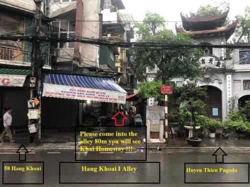 a street with signs on the side of a city at Khai Homestay in Hanoi
