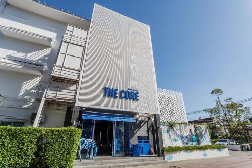 a building with a sign that reads the cure at The Core Street By Stay Now - SHA Plus in Chiang Mai