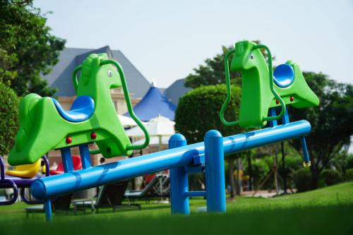 a playground with a slide in a park at Al Aziziyah Boutique Hotel By The Torch in Doha