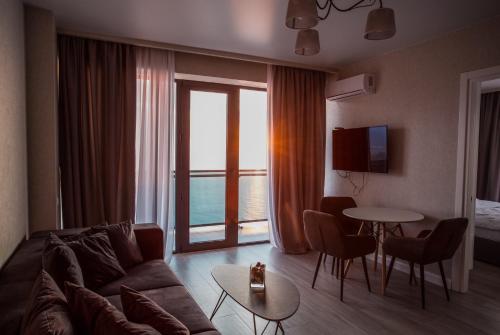 a living room with a couch and a table at The SPOT apartments - Orbi Beach Tower in Batumi
