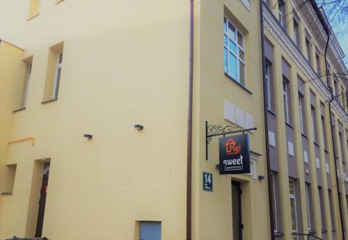 a building with a sign on the side of it at Pigi nakvyne in Šiauliai