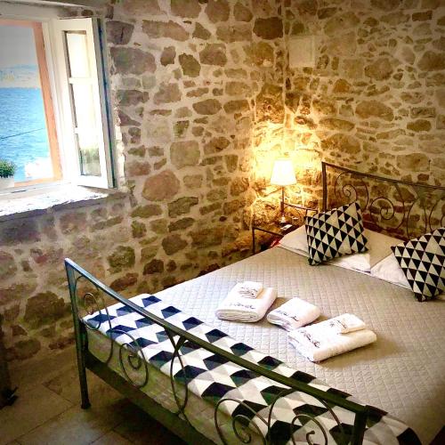 a bedroom with a bed with towels on it at City Rooms Šibenik in Šibenik