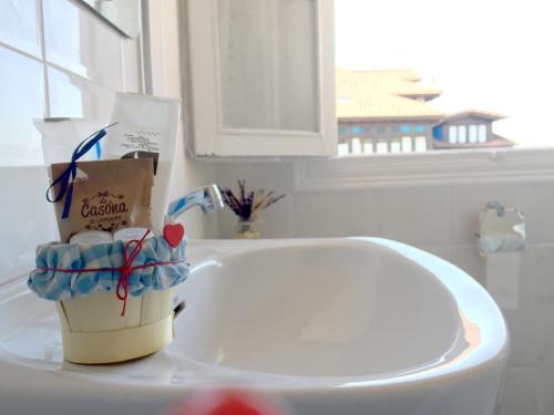 a bathroom sink with a paper cup next to a sink at La Casina de La Casona in Sobrepiedra