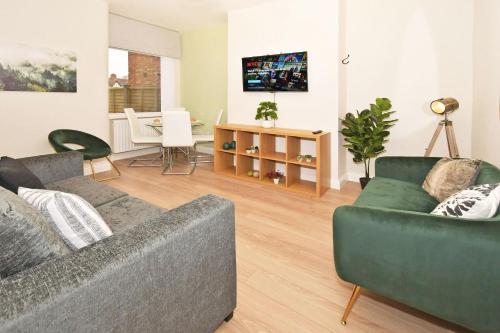 a living room with two couches and a table at Somerville House by YourStays - 4 Bedroom House in Crewe in Crewe