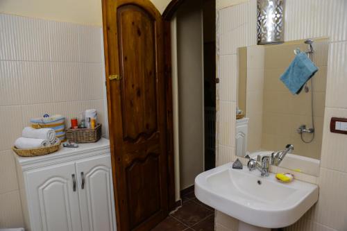 a bathroom with a sink and a mirror at Habibi Nubian Guest House-Nubian Hospitality in Aswan