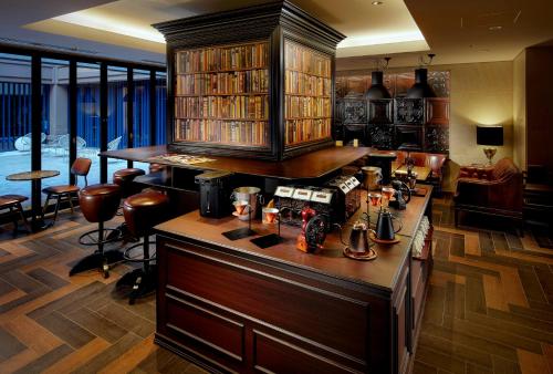 a living room with a kitchen with a counter top at Hotel Villa Fontaine Kobe Sannomiya in Kobe