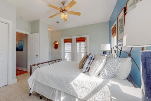 a bedroom with a bed and a ceiling fan at The Lemon Drop in Rosemary Beach
