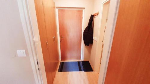 a small hallway with a door and a blue at Apartment Ski Sara Pokljuka in Bled