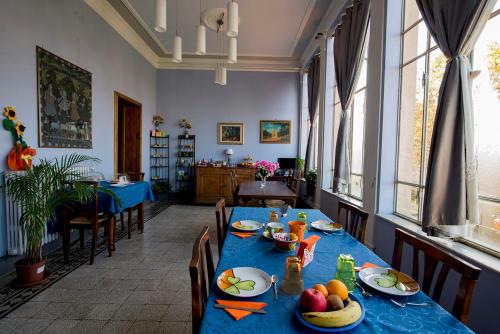 a dining room with a blue table with fruit on it at Tuscany Experience BnB in Foiano della Chiana