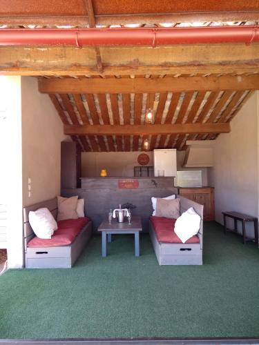 a living room with two couches and a table at Mas de Camejean in Lambesc