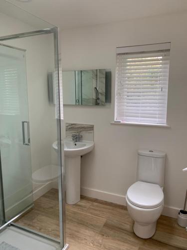 a bathroom with a toilet and a sink at The Boat House in Chichester