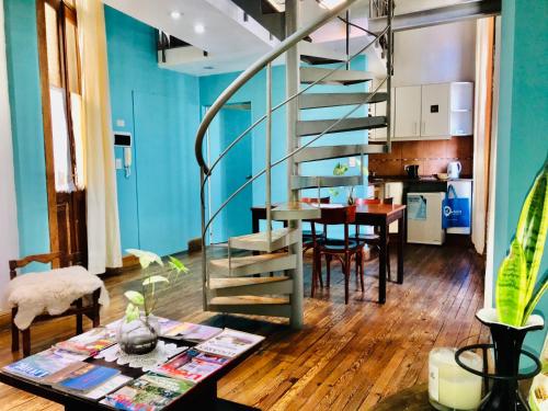 a living room and kitchen with a spiral staircase at La Casona del Alma in Buenos Aires