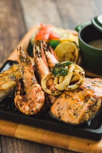 a plate of food with meat and vegetables on a table at Jannah Marina Hotel Apartments in Dubai