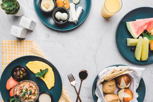 a table topped with plates of food and drinks at Jannah Marina Hotel Apartments in Dubai