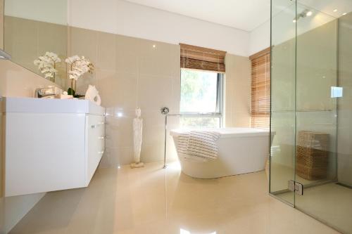 a bathroom with a tub and a glass shower at Moriarty Retreat - couple's luxe getaway in Yallingup