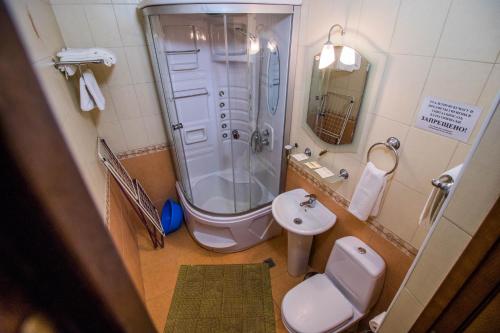 a bathroom with a shower and a toilet and a sink at Hotel Moskva in Gelendzhik