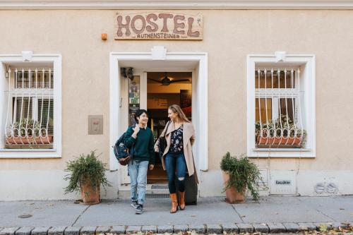 a man and a woman walking down the street at Vienna Hostel Ruthensteiner in Vienna