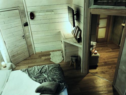 a room with a bed and a table and a desk at Cà Virò in Albosaggia
