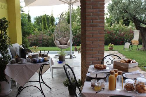 a patio with a table and chairs with food on it at Due Lune B&B in Almenno San Salvatore