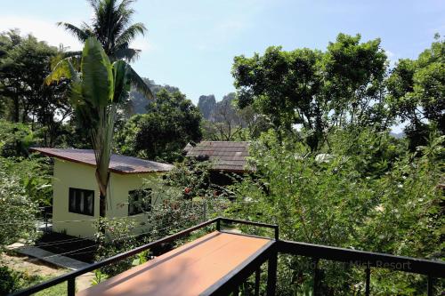 a view from a balcony overlooking a lush green hillside at Khao Sok Morning Mist Resort in Khao Sok National Park