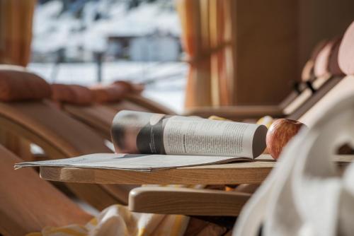 a book sitting on top of a wooden table at Hotel Kirchlerhof in Tux