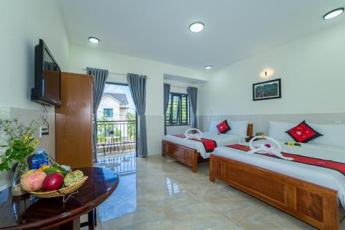 Postel nebo postele na pokoji v ubytování Coco Village Homestay Hoi An
