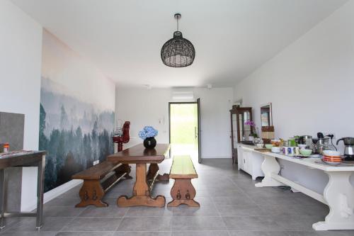 a kitchen with a table and benches in a room at Aqua&Co Bellagio - Eco conscious stay in Bellagio