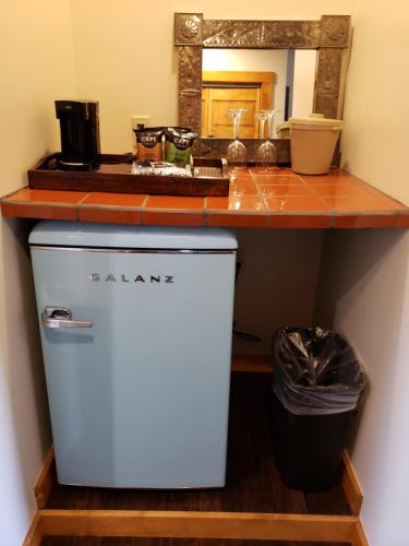 a kitchen with a counter and a trash can at Abiquiu Inn in Abiquiu