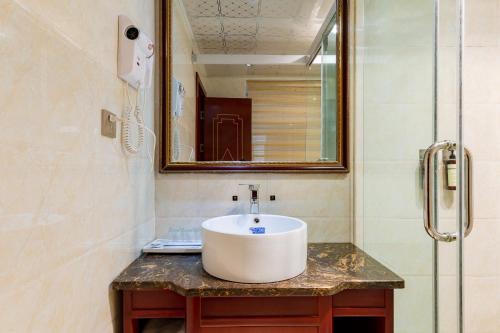 a bathroom with a sink and a shower at Floral Hotel · Shangri-la Blue Sky in Shangri-La