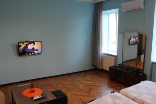 a living room with a couch and a table at Comfortable Apartment close to Central Park in Tskaltubo