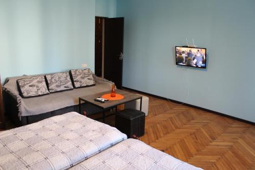 a living room with two couches and a table at Comfortable Apartment close to Central Park in Tskaltubo