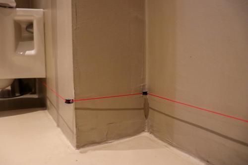 a red line on a wall next to a urinal at Fruitpark Hotel & Spa in Ochten