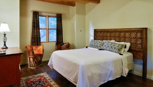 a bedroom with a large bed and a window at Abiquiu Inn in Abiquiu