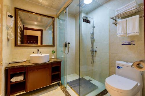 a bathroom with a shower and a toilet and a sink at Floral Hotel · Shangri-la Blue Sky in Shangri-La