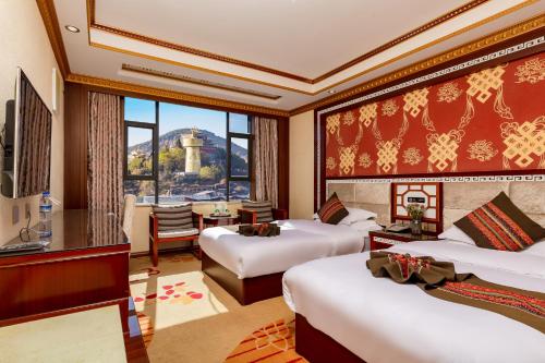 a hotel room with two beds and a window at Floral Hotel · Shangri-la Blue Sky in Shangri-La