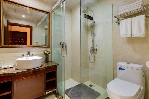 a bathroom with a shower and a toilet and a sink at Floral Hotel · Shangri-la Blue Sky in Shangri-La