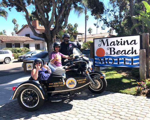 a group of people sitting on a motorcycle with a side car at Marina Beach Motel in Santa Barbara