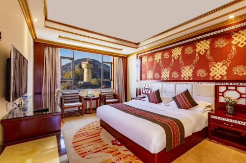 a bedroom with a king sized bed and a dining room at Floral Hotel · Shangri-la Blue Sky in Shangri-La